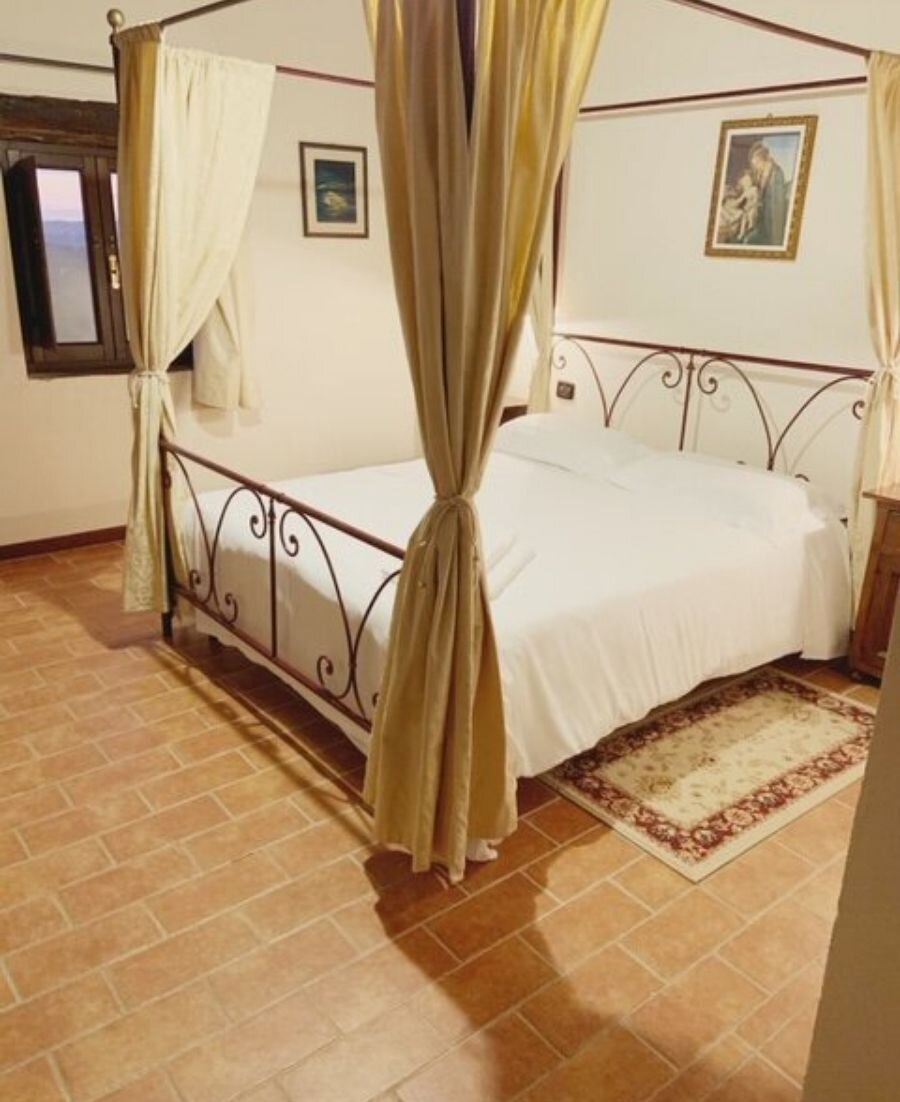 A four-poster bedroom at Villa La Tornaie, Tuscany.